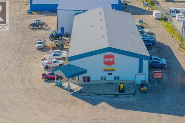 Front view of the RME commercial building with blue trim and parked vehicles. - 14250 100 Street, Rural Grande Prairie No  1, County Of