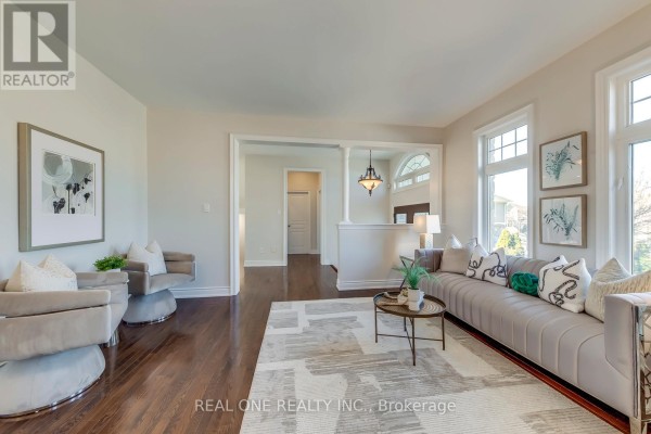 Living room with grey sofa, armchairs, coffee table, and rug - 1426 Redwing Court Oakville