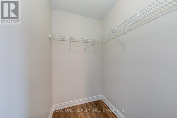 Walk-in closet with wire shelving and hardwood floors - 1426 Redwing Court Oakville