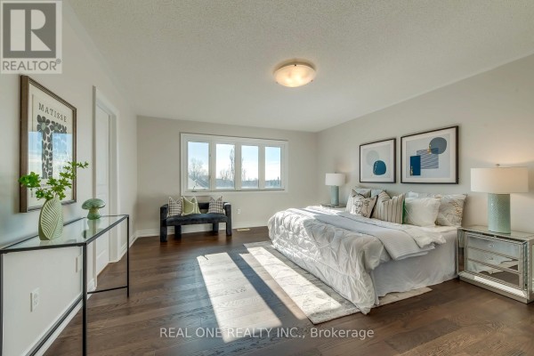 King size bed with white comforter and pillows, hardwood floors, artwork, and bench - 1426 Redwing Court Oakville