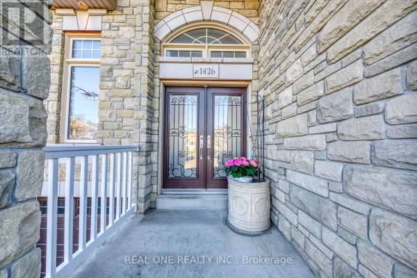 Double doors with decorative glass, stone exterior, and house number 1426 - 1426 Redwing Court Oakville