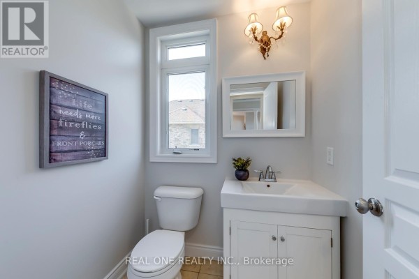 Bathroom with toilet, sink, vanity, mirror, and wall art - 1426 Redwing Court Oakville