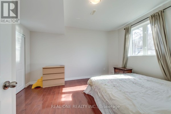 Bedroom with double bed, dresser, nightstand, and window - 1426 Redwing Court Oakville