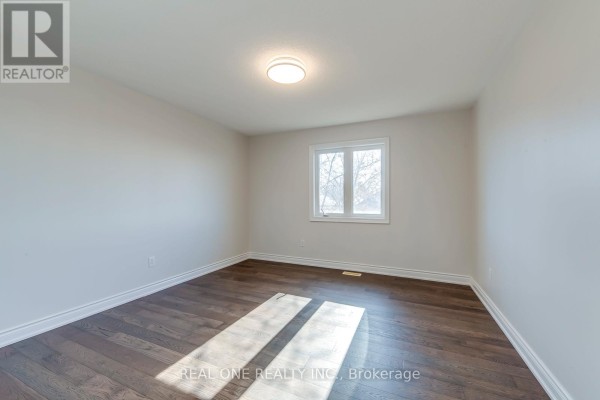 Bedroom with dark hardwood floors and white trim - 1426 Redwing Court Oakville