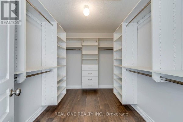 Walk-in closet with built-in shelves and drawers - 1426 Redwing Court Oakville