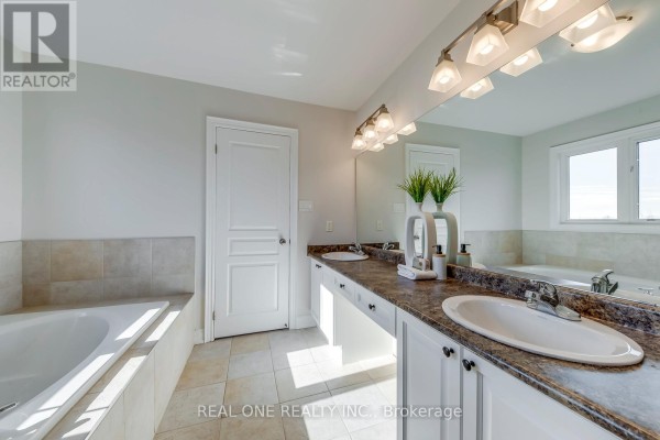 Bathroom with soaking tub and double vanity - 1426 Redwing Court Oakville