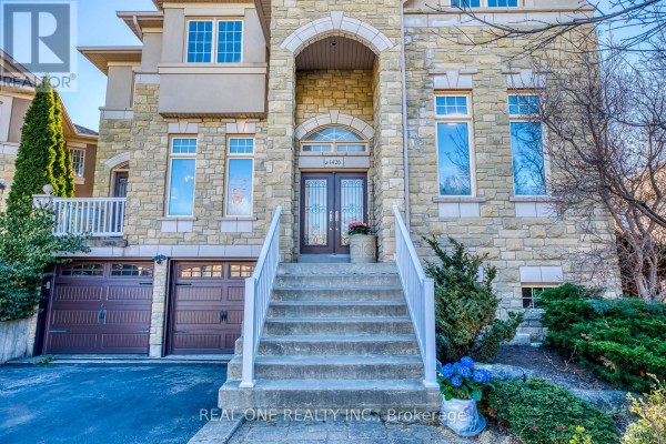 Stone house with double garage, concrete stairs, and arched entryway with double glass doors - 1426 Redwing Court Oakville