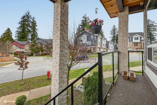 Balcony view overlooking the street with hanging plants and nearby homes. - 14298 62 Avenue, Surrey