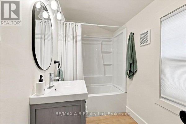 Modern bathroom with vanity, sink, mirror, tub and shower - 143 Britannia Street Stratford