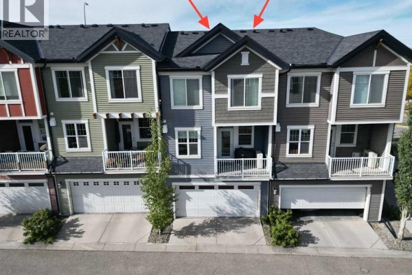 Aerial view of townhouse units showing roofs, balconies, and garages. - 143 Nolan Hill Boulevard Nw, Calgary