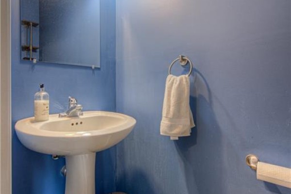 Pedestal sink with chrome faucet and towel ring on blue wall. - 1430 Highland Road W Unit# 19a, Kitchener