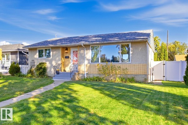 A wider front view of the house, highlighting the windows and entry. - 14312 89a Av Nw, Edmonton