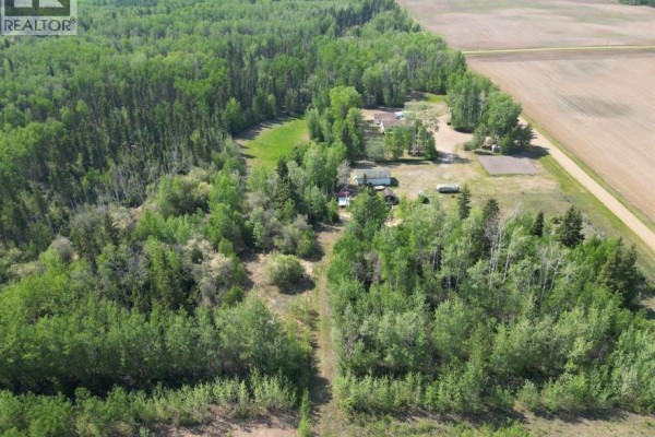 View of the property with a swing set and snow-covered yard. - 14371 Twp Rd 1072, Rural Mackenzie County