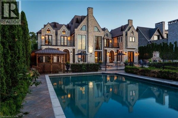 Rear of stone mansion with swimming pool and gazebo. - 144 Lake Drive E, Georgina