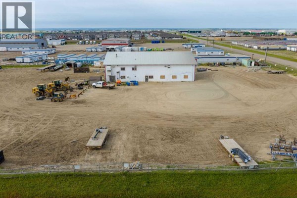 Aerial view of a commercial property showing the large building and expansive gravel yard. - 14410 102 Street, Rural Grande Prairie No  1, County Of