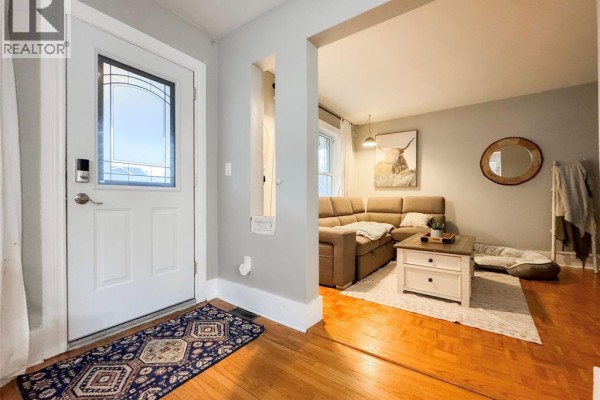 Entryway with door, decorative mirror, and living area visible - 1444 Bernard Unit# Main, Windsor