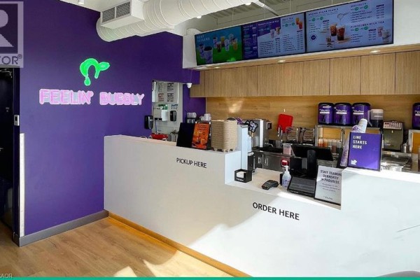 Interior counter area of the bubble tea shop with a white counter and purple walls. - 1447 Water Street S Unit# 6, Peterborough