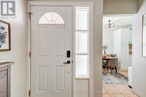 Interior view of white front door with frosted glass sidelights and transom. - 145 - 10 Bowman Way, Markham