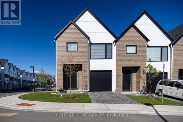Front exterior of townhouses with garages, modern siding, and driveways. - 145 - 1965 Upperpoint Gate, London South