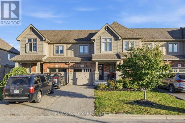 Front exterior view of townhouses with driveways and landscaping in daylight. - 145 Hutchinson Drive, New Tecumseth
