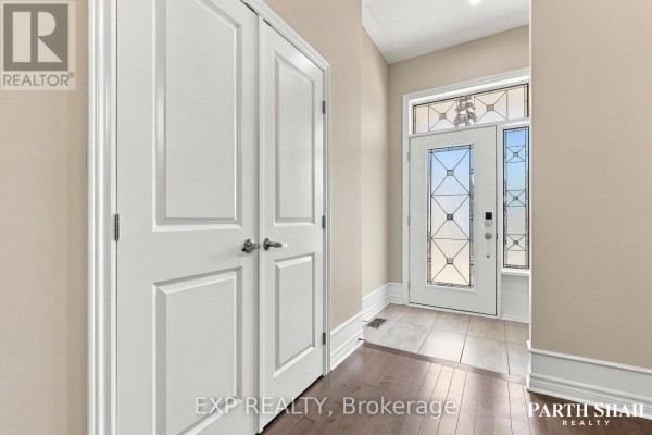 Interior view of a bright entryway with double white doors and a glass door. - 145 Oxford Street W, North Grenville