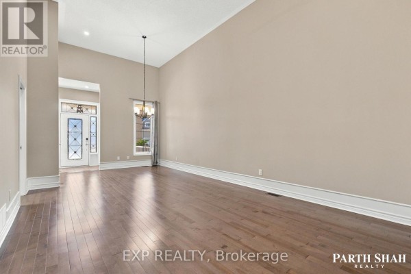 Spacious living room with high ceilings, hardwood floors, and a view of the entrance. - 145 Oxford Street W, North Grenville