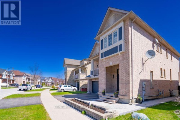 Side exterior view of a brick house showing multiple windows and a satellite dish. - 145 Silver Maple Road, Richmond Hill