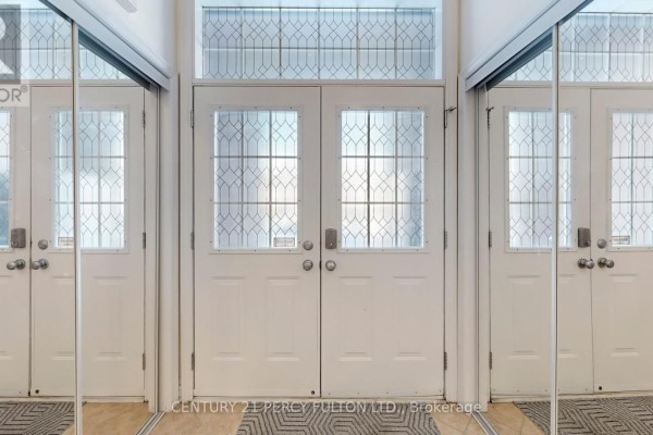 Interior double doors with glass inserts and mirrored walls on either side. - 145 Silver Maple Road, Richmond Hill