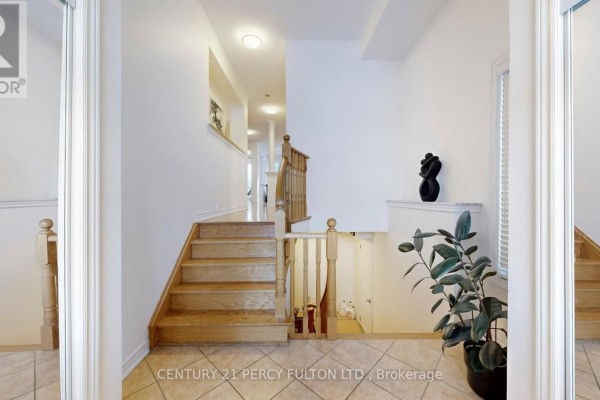 Interior view of a staircase with wooden steps and banisters, leading to hallways. - 145 Silver Maple Road, Richmond Hill