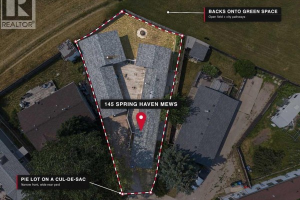 Aerial view of the property lot at 145 Spring Haven Mews, outlined in red. - 145 Spring Haven Mews Se, Airdrie