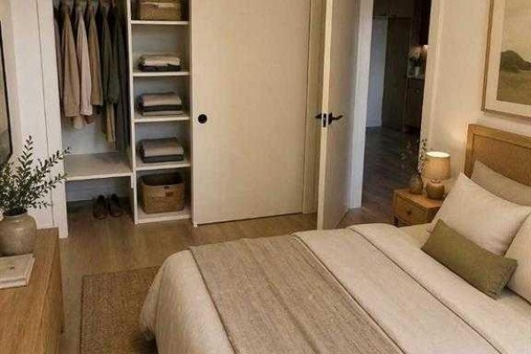 Bedroom with a queen-sized bed, wooden headboard, and a built-in closet with organized shelving. - 1450 19 Avenue Sw, Calgary