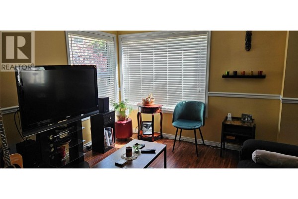 Deck area with white railing, planters, and a metal garden screen. - 1458 Penticton Avenue Unit# 119, Penticton