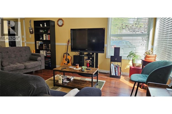 Kitchen corner with light wood cabinets, white dishwasher, microwave, and toaster oven. - 1458 Penticton Avenue Unit# 119, Penticton