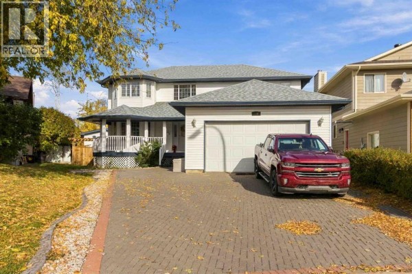 Front exterior of a two-story house with a double garage on a paved driveway. - 146 Maclaren Crescent, Fort Mcmurray