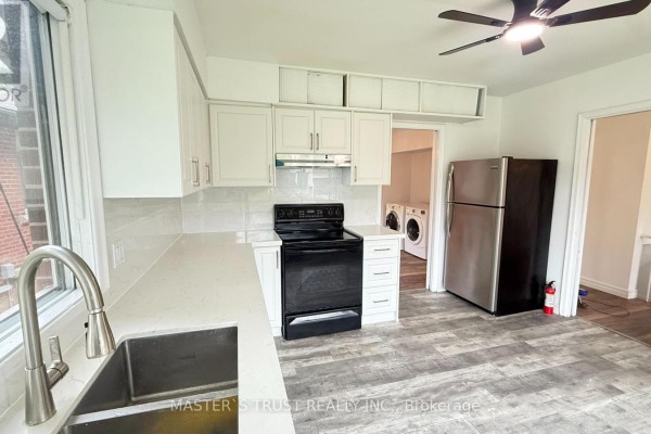 White kitchen with stainless steel appliances and quartz countertops. - 146 Yorkview Drive, Toronto