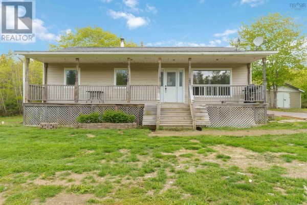 The beige bungalow features a long covered porch with support posts and a central set of stairs. - 1460 Hampton Mountain Road, Hampton
