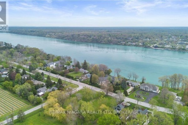 Aerial view of the Niagara River showcasing trees and homes along the waterfront. - 14662 Niagara River Parkway, Niagara On The Lake