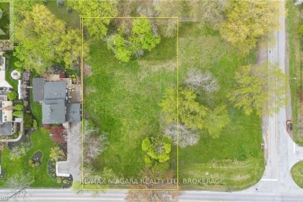 Overhead view of a vacant lot outlined in yellow, surrounded by trees and homes. - 14662 Niagara River Parkway, Niagara On The Lake