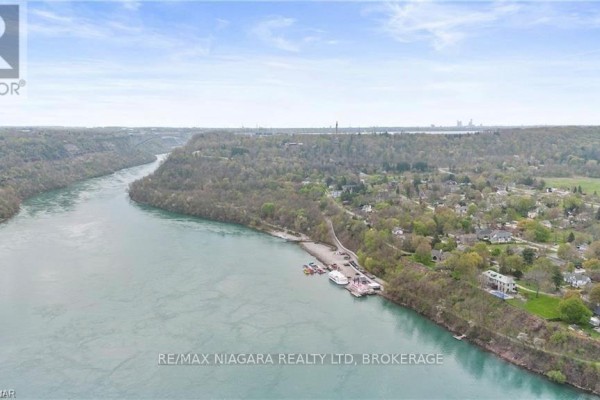 Panoramic view of the Niagara River with a distant shoreline and residential areas. - 14662 Niagara River Parkway, Niagara On The Lake