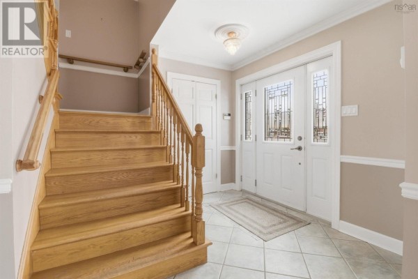 Living room with bay window, grey walls, white trim, and hardwood floors. - 147 Flagstone Drive, Colby