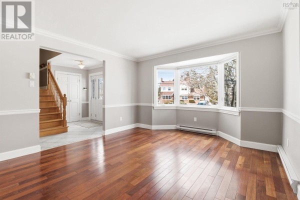 Bedroom with neutral walls, white trim, and light wood floors. - 147 Flagstone Drive, Colby