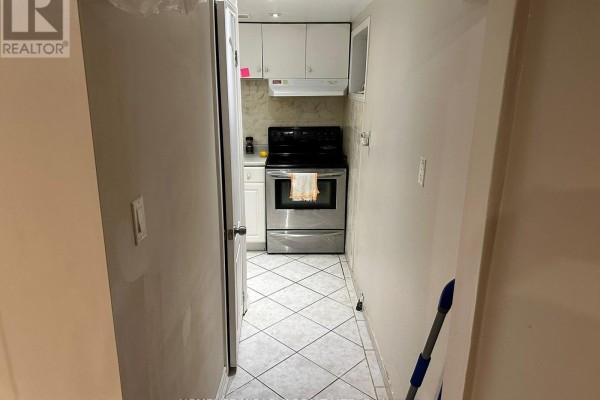 Kitchen counter space with appliances and a view of a door and window. - 1476 Cawthra Road, Mississauga