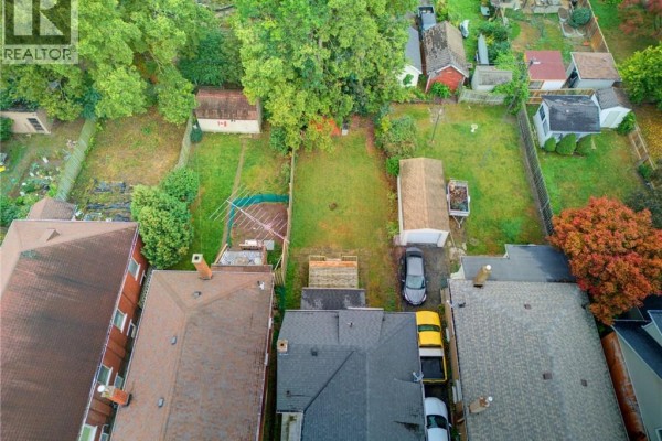 Aerial view of backyard lots with a garage, shed, and grassy areas. - 148 Albion Street, Brantford