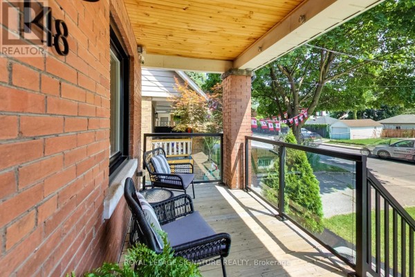 View from the porch showing glass railings and outdoor seating. - 148 Mortimer Avenue, Toronto