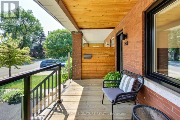 Porch with wooden decking, seating, and a view of the street. - 148 Mortimer Avenue, Toronto