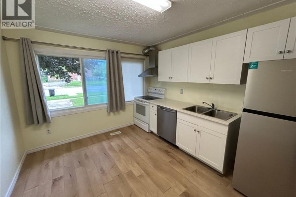 Kitchen with stainless steel appliances, white cabinets, and double sink - 148 Weber Street N Unit# A Waterloo