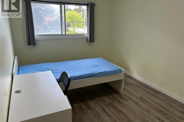 Bedroom with single bed, desk, chair, and window - 148 Weber Street N Unit# A Waterloo