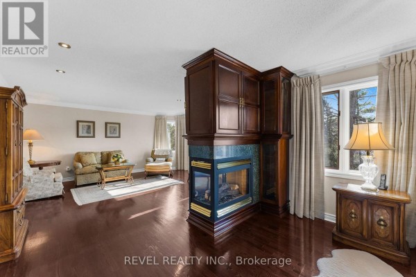 Living room with fireplace and built-in cabinetry - 1486 Ashwood Gate Pickering