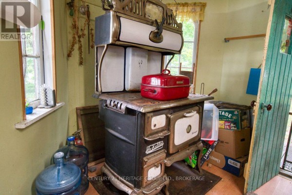 Antique wood-burning stove with red roaster - 148b Oak Shores Lane Frontenac