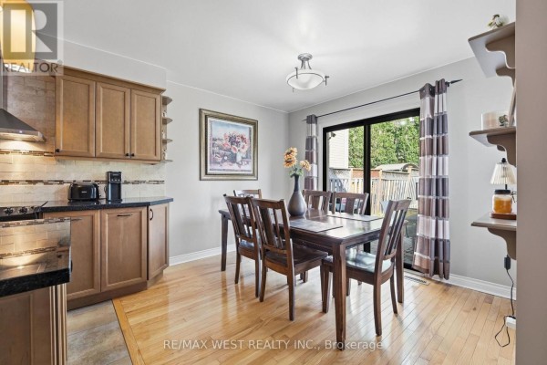Dining table and chairs near kitchen with sliding glass door - 149 Deerglen Terrace Aurora